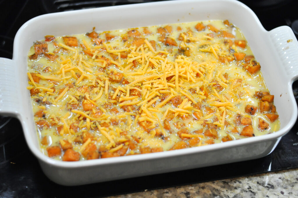 up close image of uncooked egg casserole with cheese on top
