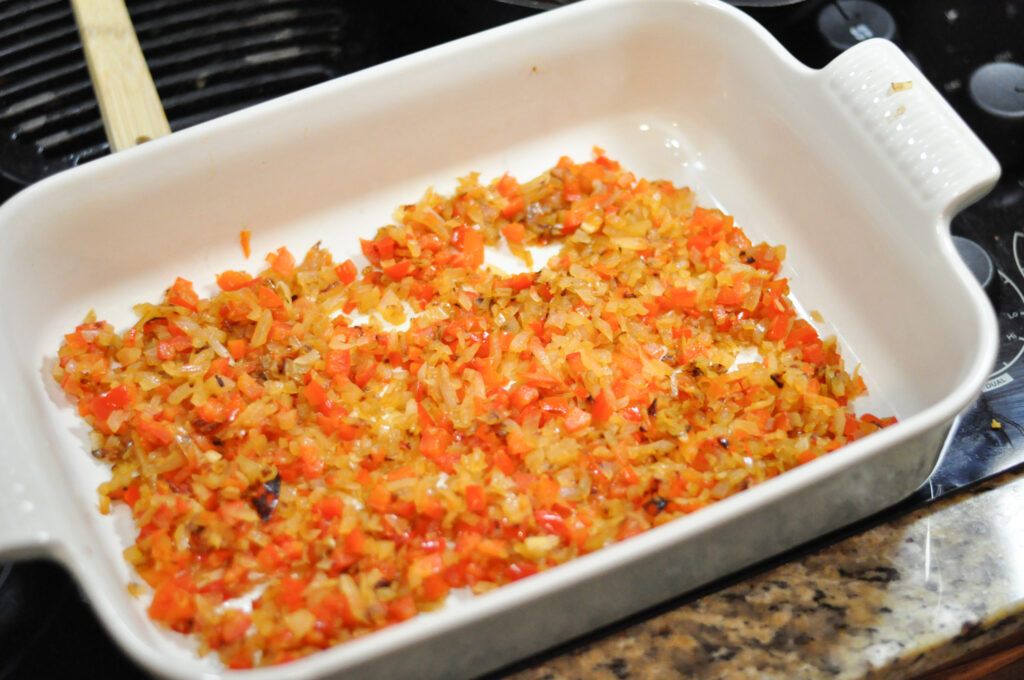 casserole dish with cooked peppers and onions in it