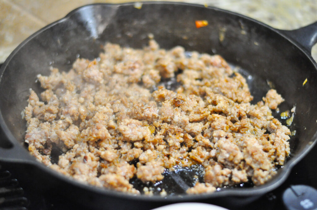 black skillet with cooked sausage in it