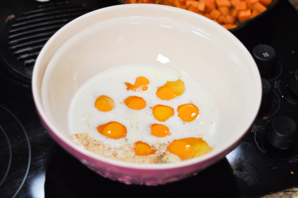 up close image of bowl with milk and raw eggs in it
